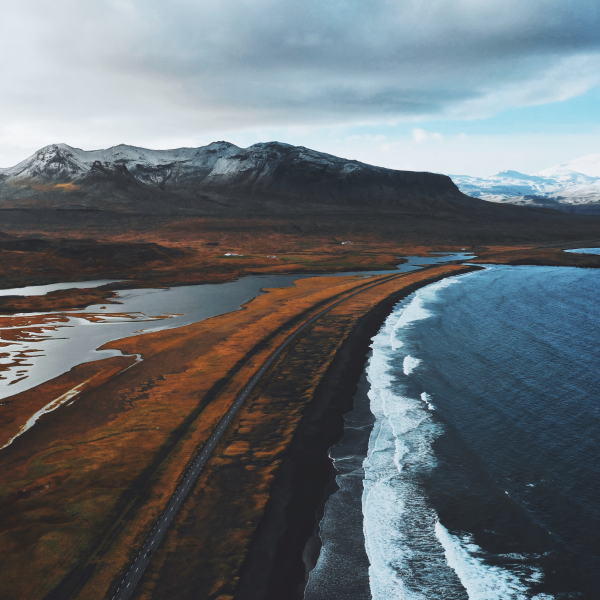 Events Guys An aerial view of a beach in Iceland, capturing the natural beauty and serene landscape.