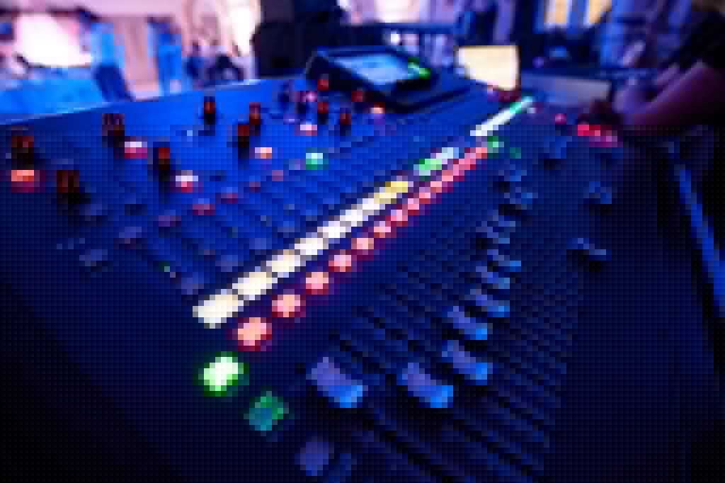 Events Guys A close up of a mixing board at an event.
