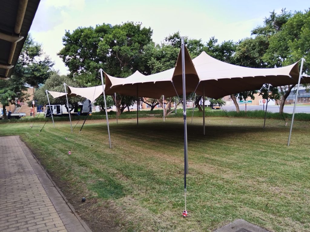 Explore South Africa's Finest Stretchy Tents with Me! 2 Events Guys A stretchy tent set up in a grassy area.