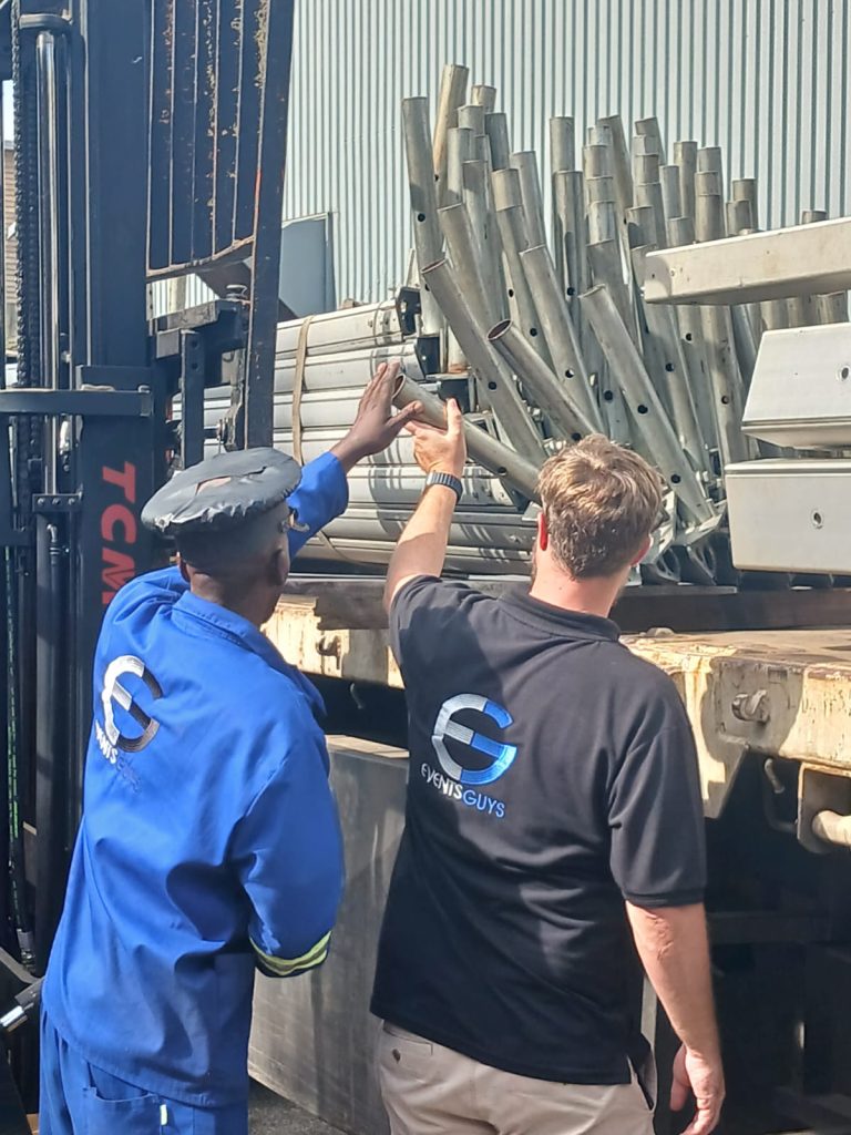 Ensuring Top-notch Event Hiring: Your Guide by Events Guys 2 Events Guys Two men standing next to a forklift in a warehouse with a glass coffee table.