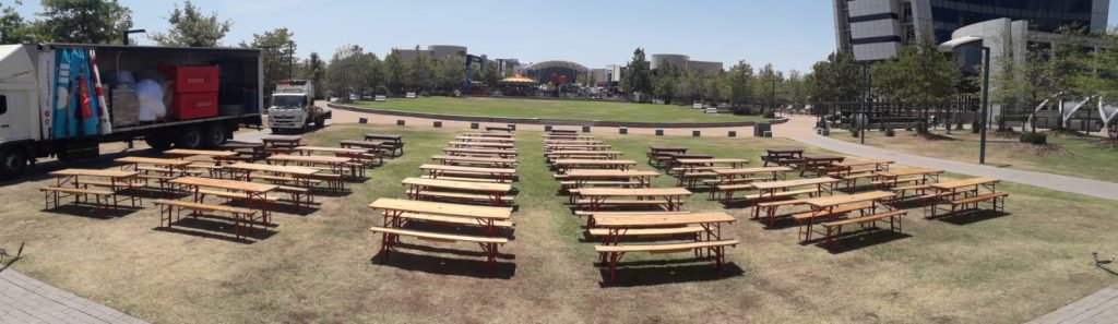 Discover Top-Notch Hiring Services Near Me in South Africa 2 Events Guys A group of tables and chairs are set up in a park, available for hire.