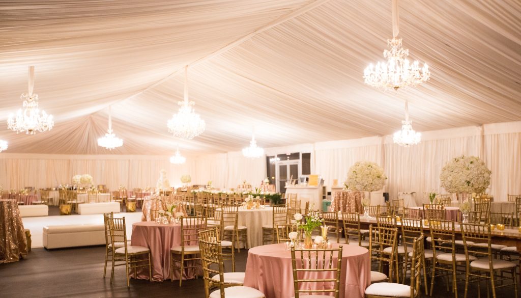 Revamp Your Gatherings with Superior Event Decors in South Africa 2 Events Guys A beautifully decorated white tent with elegant gold tables and chairs, perfect for a wedding ceremony or reception.