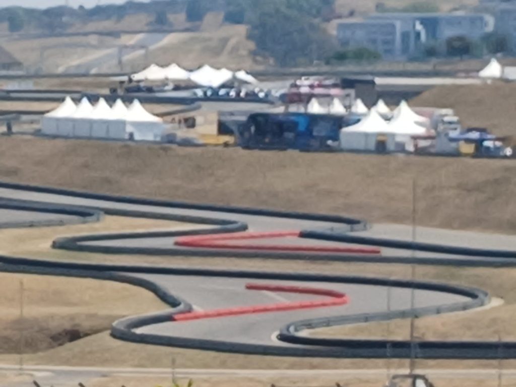 Discover South Africa's Best Waterproof Stretch Tents Today 3 Events Guys A race track with a lot of tents for hire in the background.